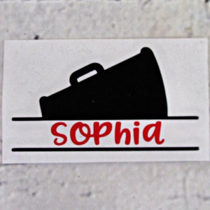 May include: A black silhouette of a megaphone with a white handle, with the name "Sophia" written in red below it.