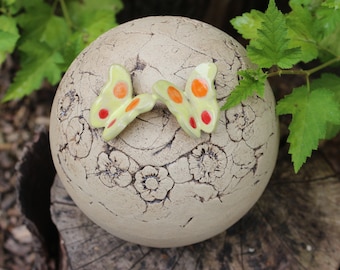 Garden ball with flower wreath and two butterflies, garden decoration, garden ceramics