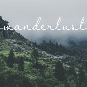 May include: A misty mountain landscape with the word "wanderlust" written in white cursive script with arrows on either side.
