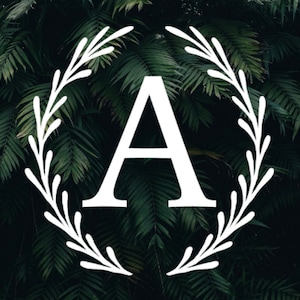 May include: A white letter A in a white wreath against a dark green leafy background.