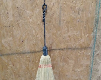Blacksmith hand forged fireplace broom with twisted handle.