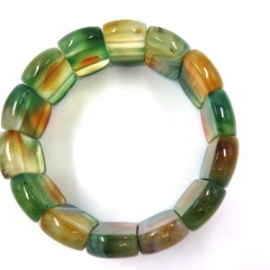May include: A green and brown agate stone bracelet with square-shaped beads.