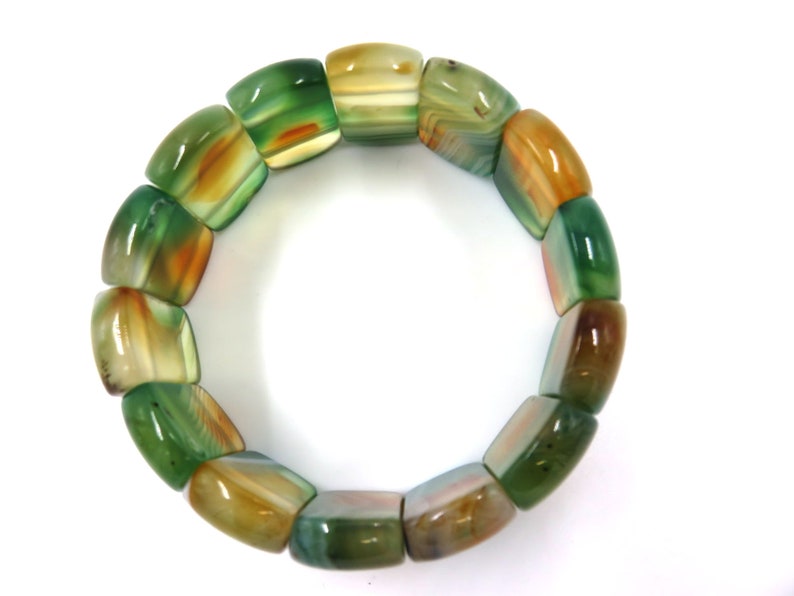 May include: A green and brown agate stone bracelet with square-shaped beads.