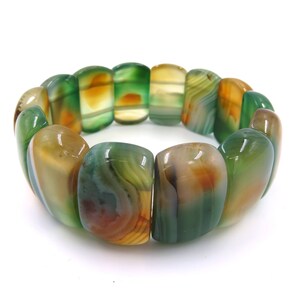 May include: A green, brown, and white agate stone bracelet with a stretchy band.