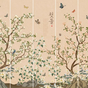 May include: A digital art print featuring a traditional Asian-inspired design with a delicate floral motif. The print depicts a blooming tree with white flowers and green leaves, surrounded by butterflies and birds. The text "첫돌" is written in Korean script on the right side of the print.
