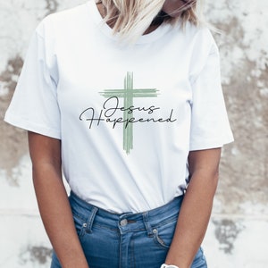 May include: White t-shirt with a green cross and the text "Jesus Happened" in black.