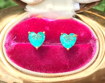 May include: A pair of heart-shaped earrings with turquoise gemstones set in gold.