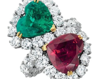 May include: A heart-shaped emerald and ruby ring set in white gold with a halo of diamonds.