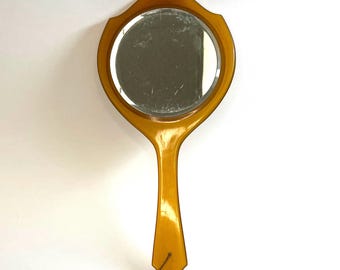 Art Nouveau Hand Mirror Beveled Glass and Translucent Engraved Caramel Colored Bakelite or Celluloid Vintage Piece in Very Good Condition