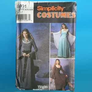 May include: Simplicity Costumes sewing pattern number 9891 for sizes 14, 16, 18, and 20. The pattern includes three different dress designs: a long, dark grey dress with a belt, a long, light blue dress with long sleeves, and a brown dress with a lace-up bodice.