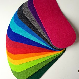 May include: A fan-shaped arrangement of 13 felt fabric swatches in various colors, including green, yellow, orange, red, blue, purple, and gray.