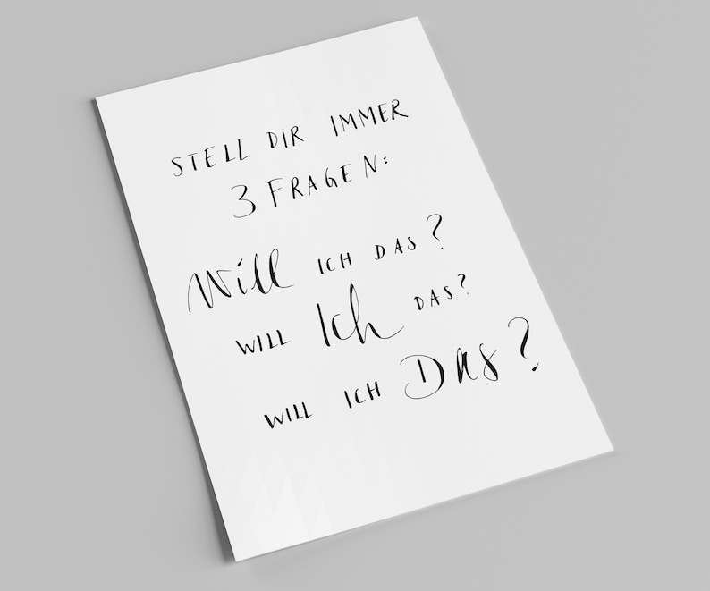 May include: A white sheet of paper with black handwritten text that reads "STELL DIR IMMER 3 FRAGEN: Will ICH DAS? WILL Ich DAS? WILL ICH Das?"