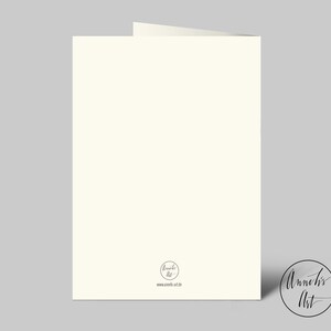 May include: A folded, off-white greeting card with a simple design. The card has a rounded logo in the lower right corner with the text "Annelis Art" and the website address. The card is set against a light gray background.