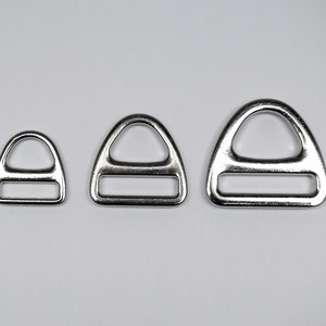 Könnte beinhalten: Drei silberne D-Ringe in verschiedenen Größen. Die Ringe sind aus Metall und haben eine glatte, polierte Oberfläche.