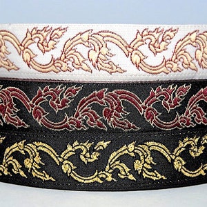 May include: Three rolls of black, white, and burgundy ribbon with a gold and white floral pattern.
