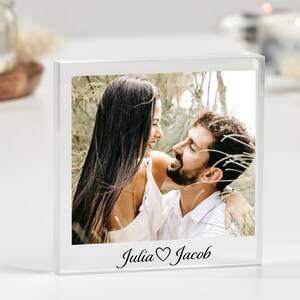 May include: A clear acrylic photo block with a picture of a couple looking at each other. The text "Julia ♥ Jacob" is printed on the bottom of the block.