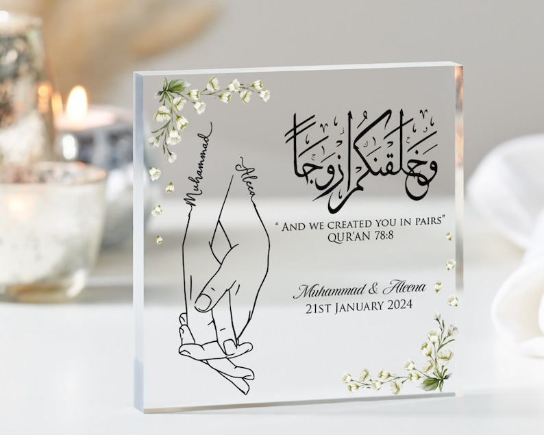 Muslim wedding gift with image of holding hands personalised with names, Islamic quote with date. White jasmine floral artwork is printed in two corners. Bestseller for Muslim gifts for him and wedding Muslim gifts.