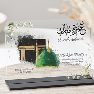 Clear plaque with black stand for Umrah Mubarak gift. Printed with Islamic quote with personalised family name and quote with dates. Bestseller for Eid mubarak gifts and Muslim gifts for couples and families.