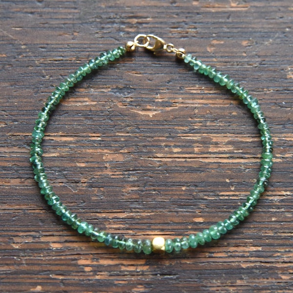 Emerald and solid gold bracelet.  Luscious green Colombian Emerald centered with a solid 18k gold nugget gemstone bead bracelet