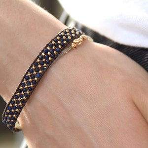 Lapis Lazuli gemstone and solid gold loom woven bead bracelet, with brown leather edge, and solid 14k gold closure.