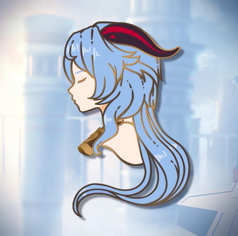 May include: A gold-coloured enamel pin featuring a blue-haired anime character with red horns. The character is wearing a gold necklace and has their eyes closed.