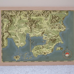May include: A vintage-style map of the Kanto region from the Pokemon video game series. The map features various locations, including cities, towns, and landmarks. The map is framed in a light wood frame.