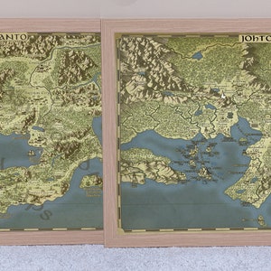 May include: Two framed maps of the Kanto and Johto regions from the Pokemon video game series. The maps are in a vintage style with a light blue ocean and green landmasses. The Kanto map features the text "KANTO" in the upper right corner, while the Johto map features the text "JOHTO" in the upper left corner. The Johto map also features a red and white Pokeball symbol in the lower right corner.