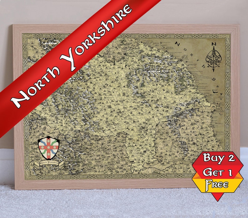 May include: A framed map of North Yorkshire, England, in a vintage style with a compass rose in the top right corner. The map is printed on a cream-coloured background with brown and black lines. The map is surrounded by a brown wooden frame.