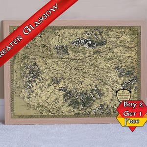 May include: Framed map of Greater Glasgow in a light wood frame. The map has a vintage aesthetic with detailed topography and city features. A red banner reads "Greater Glasgow". A "Buy 2 Get 1 Free" promotion is visible.