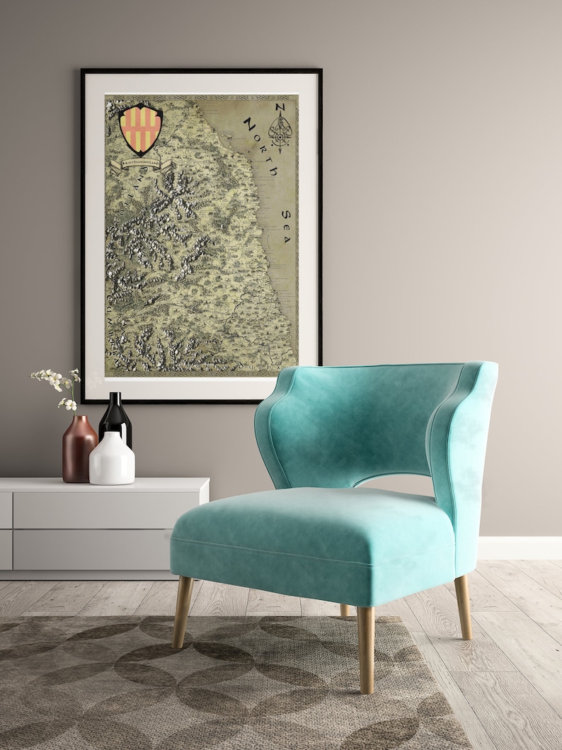 May include: A teal blue armchair with a high back and a cut-out design in the back. The chair is sitting on a patterned rug in front of a white wall and a framed map with the text "North Sea" on it.