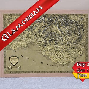 May include: Framed map of Glamorgan with a detailed topographical design. The map is in a light beige colour with dark brown and white shading, and is framed in a light wood colour. A red banner with the word "GLAMORGAN" is across the top.