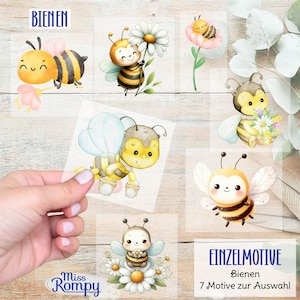 Peut inclure: Sept images numériques de clipart représentant de jolies abeilles de dessin animé avec des fleurs et des rayons de miel. Les images sont sur un fond blanc avec le texte "Bienen" et "Einzelmotive" en noir.