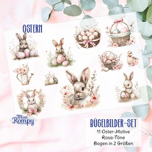 Könnte beinhalten: Ein Bogen mit Bügelbildern zum Thema Ostern, mit Aquarellillustrationen von Hasen, Eiern, Körben und Blumen. Der Text "OSTERN" steht oben und "BÜGELBILDER-SET" unten, zusammen mit anderem deutschen Text. Die Designs sind in Rosa- und Pastelltönen gehalten.