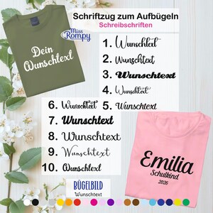 Könnte beinhalten: Ein olivgrünes T-Shirt mit dem Text "Dein Wunschtext" in weißer Schrift. Ein rosa T-Shirt mit dem Namen "Emilia" und "Schulkind 2026" in schwarzer Schrift. Das Bild zeigt auch Beispiele für Bügelbilder.