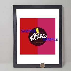 May include: Framed print featuring the Wonka logo with a top hat, set against a red and magenta background. The text "Wonka fudge mallow" is displayed in a circular design. The print is in a black frame.