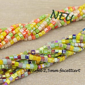 Könnte beinhalten: Stränge bunter, facettierter Würfelperlen in Gelb-, Grün-, Orange- und Lilatönen. Die Perlen sind ca. 2,5 mm groß. Das Wort "NEU" ist im Bild zu sehen.