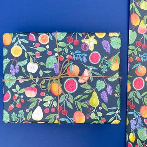 Summer fruit wrapping paper printed using vegetable inks. Fruits including, watermelon, lemons, oranges, pears, apples, grapes, mangoes, figs, peach, cherries. strawberries, raspberries, blackberries and blueberries. Originally painted with watercolours. Printed on a dark teal background.