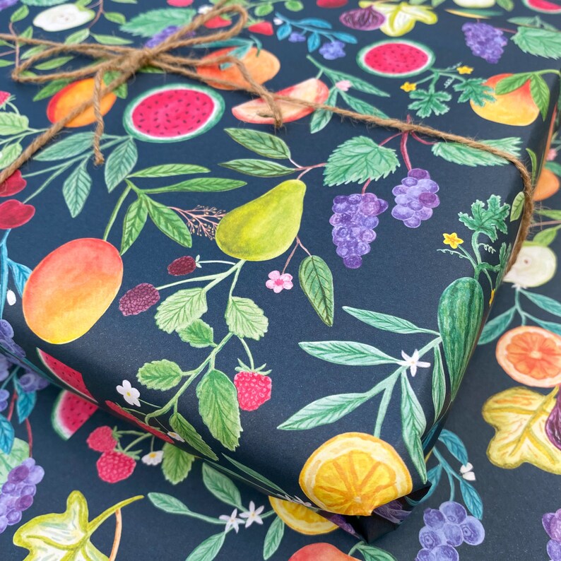 Summer fruit wrapping paper printed using vegetable inks. Fruits including, watermelon, lemons, oranges, pears, apples, grapes, mangoes, figs, peach, cherries. strawberries, raspberries, blackberries and blueberries. Originally painted with watercolours. Printed on a dark teal background.
