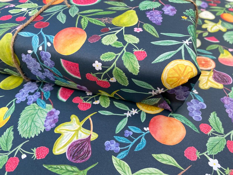 Summer fruit wrapping paper printed using vegetable inks. Fruits including, watermelon, lemons, oranges, pears, apples, grapes, mangoes, figs, peach, cherries. strawberries, raspberries, blackberries and blueberries. Originally painted with watercolours. Printed on a dark teal background.