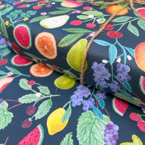 Summer fruit wrapping paper printed using vegetable inks. Fruits including, watermelon, lemons, oranges, pears, apples, grapes, mangoes, figs, peach, cherries. strawberries, raspberries, blackberries and blueberries. Originally painted with watercolours. Printed on a dark teal background.