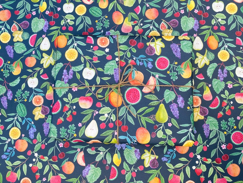 Summer fruit wrapping paper printed using vegetable inks. Fruits including, watermelon, lemons, oranges, pears, apples, grapes, mangoes, figs, peach, cherries. strawberries, raspberries, blackberries and blueberries. Originally painted with watercolours. Printed on a dark teal background.