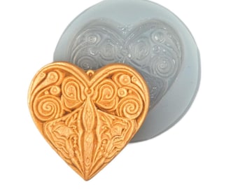 May include: A gold-coloured heart-shaped mould with a detailed, intricate design. The mould is made of silicone and is used for making decorative items.
