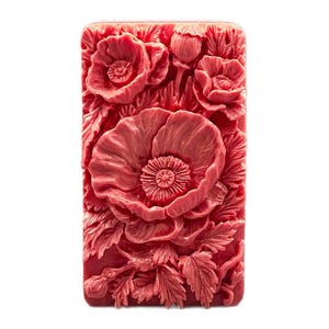 May include: A red silicone mold with a detailed design of poppy flowers. The mold is rectangular and has a smooth surface.