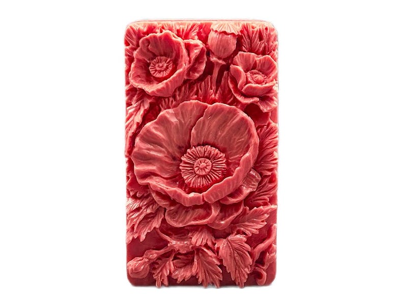May include: A red silicone mold with a detailed design of poppy flowers. The mold is rectangular and has a smooth surface.