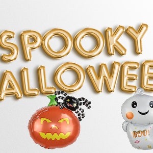 May include: Gold foil balloon letters spell "SPOOKY HALLOWEEN" above a pumpkin and ghost balloon. The pumpkin is orange with a black spider and the ghost says "BOO!"