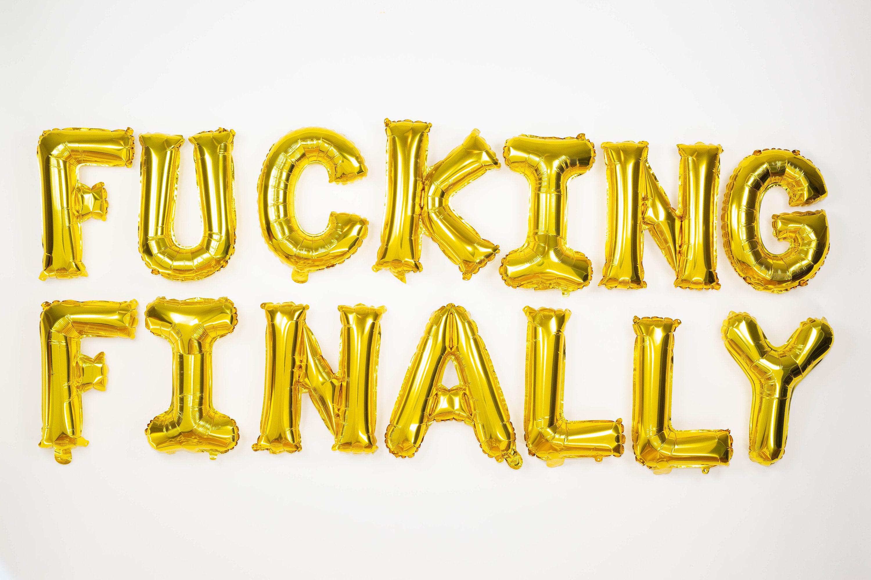 balloons reading "FUCKING FINALLY"