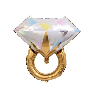 May include: A gold and iridescent foil balloon shaped like a diamond ring. The diamond is clear with rainbow accents.