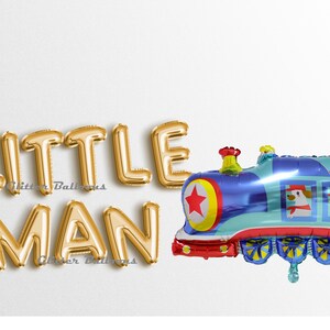 May include: Gold foil balloons spelling "LITTLE MAN" with a blue, red, and yellow train balloon with a red star and two cartoon dogs on the side.