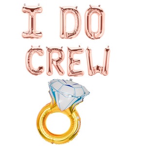 May include: Rose gold foil balloons spelling "I DO CREW" with a gold ring and diamond balloon.