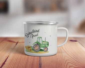 May include: White enamel mug with a green tractor illustration and the text "Schulkind Paul" on it. The tractor is pulling a bale of hay.